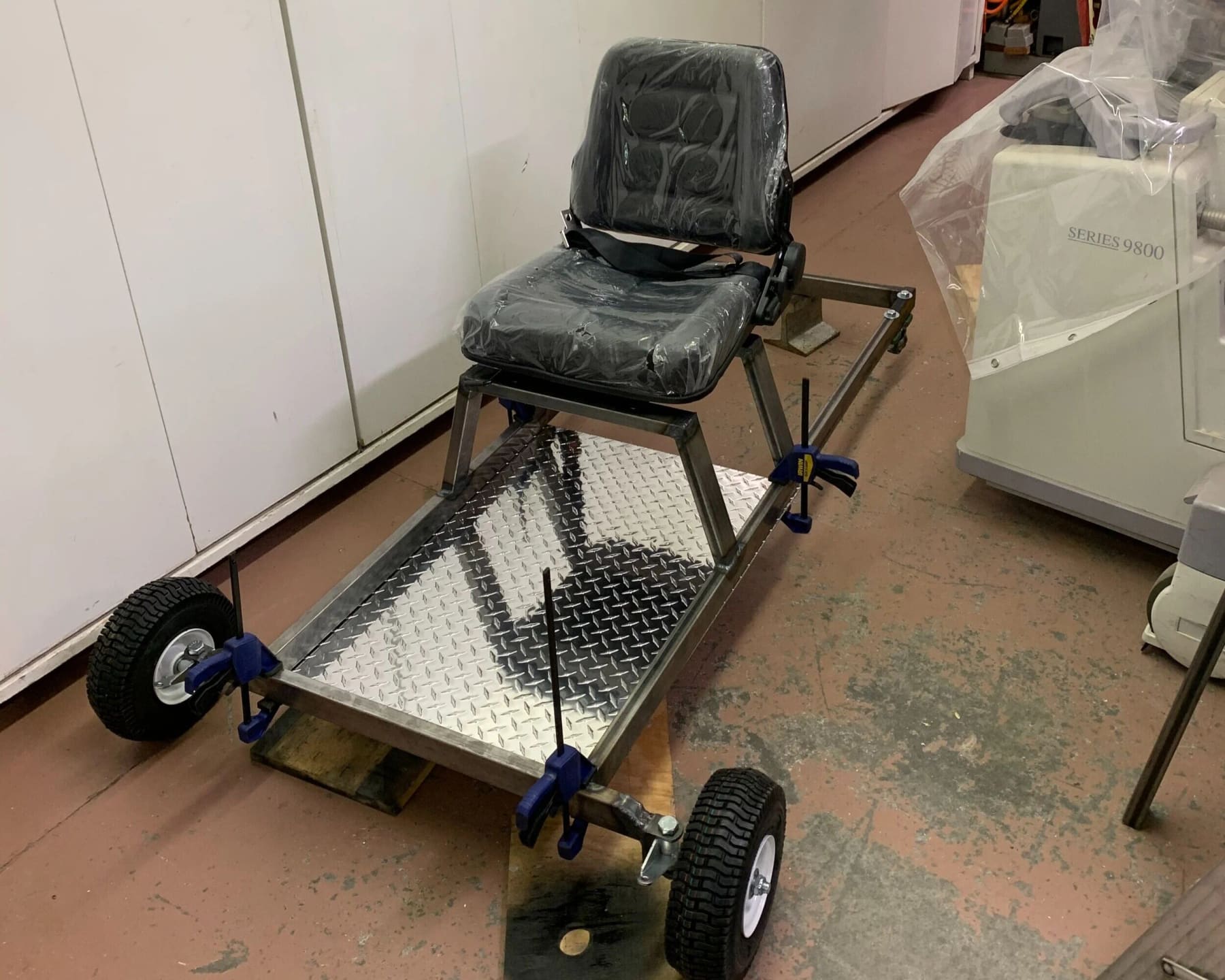 Forklift seat mounted to the frame