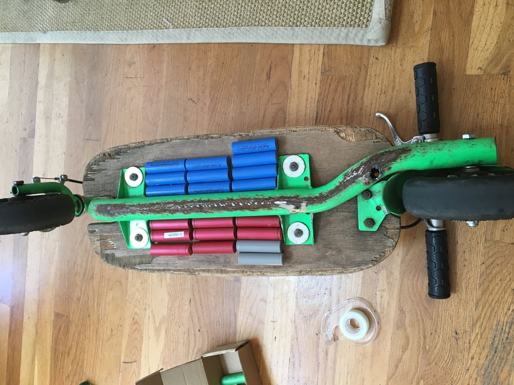 Scooter deck opened up, showing a hand-built 18650 pack